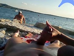 On a nude beach the wife stokes my cock while a buety girl white watches