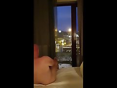 wank on bed curtains open in hotel