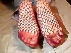 Fofi takes off her sneakers and her fishnet socks