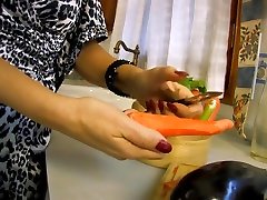 A brunette woman enjoys her vegetables!