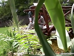 Shaved teen gets anal on the garden bridge