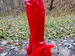 Lady L sexy walking with extreme red lana thoedes in forest.