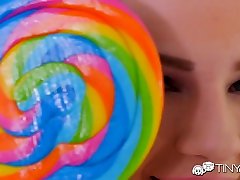 Cute bright teen sucks a lollipop as her wet pussy is sensually licked