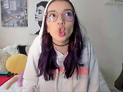 This alternative Colombian with purple hair and multiple body piercings loves having a good cock in her slutty mouth