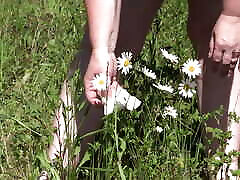 Piss on flowers in a public park. Mature BBW with hairy pussy and fat ass watering flowers with her urine outdoors. ASMR