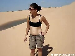 Naughty brunette chick flashing her lovette tug in desert