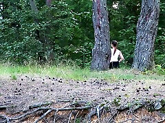 Chubby white brunette lady in the forest squats and pisses on the hill