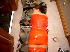 Weird Woman Wrapped In Orange Tape Asleep