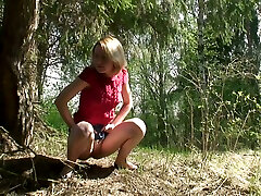 Hot blonde young chick from Russia pissed under the tree