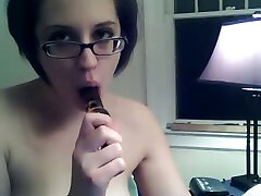 Dirty brunette chick in glasses pleases her asshole with dildo