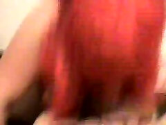 My busty mature wife wearing a red wig and blowing my dick
