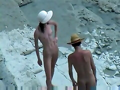 Spy video of horny nudist couple fucking doggy style on a beach