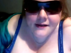 Fat and skanky white bitch in sunglasses on the webcam