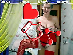 Hot housewife Lukerya in red lingerie with her dish hot video fantasies in the kitchen in front of fans on the webcam online.