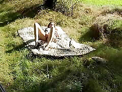 sweet soni louyan xxxx video lies naked on the meadow and fingers her vagina in the sunshine