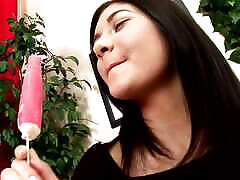 Young Chinita with long black hair and tanned body eats popsicle while being played with and fucked