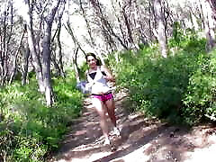 A cute runner takes a break to suck a huge while cal phone in the forest