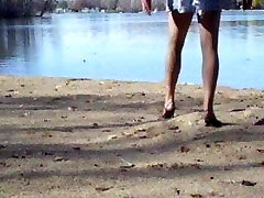 Crossdresser at the lake in hosepipe and heels