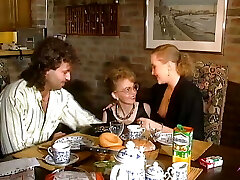 Two stunning German chicks sharing a loaded jizz-shotgun on the kitchen table