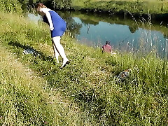 Nudist beach. Public nudity. Sexy Cougar without panties and boulder-holder sunbathes naked is not shy about fisherman. Naked in public. Milf