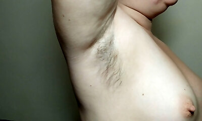 Ellie shows her unshaved armpits and plays with them