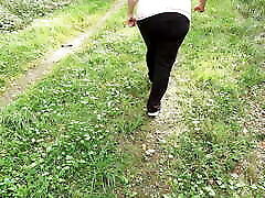 Slapping her tits while hiking naked