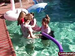 Four girls are enjoying stripping in the swimming pool, with one lucky guy joining them