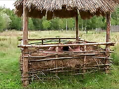 Hay proves to be the perfect cushion as the brunette gets her asshole stretched outdoors