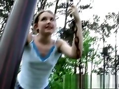 Kitty goes outside to play on the bars and pulls up her blouse and dress