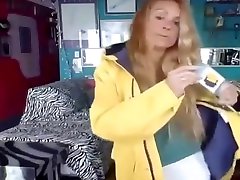woman shows off her new yellow raincoat and long wellies