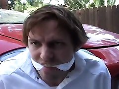 Blake tied up and cleave gagged in parking garage.