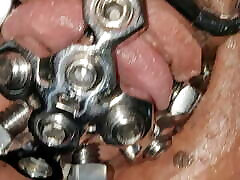 close up of the set screw in my chastity cage