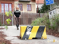 Swee cute blondie crouches behind the barrier to pee