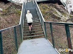 Curvy and sexy blondie crouches on the stairs and urinates