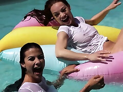 Lesbian girlfriends having fun at a pool