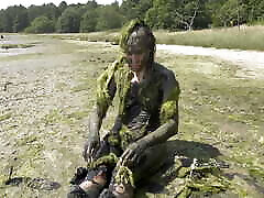 Estuary mud girl playing in the nude